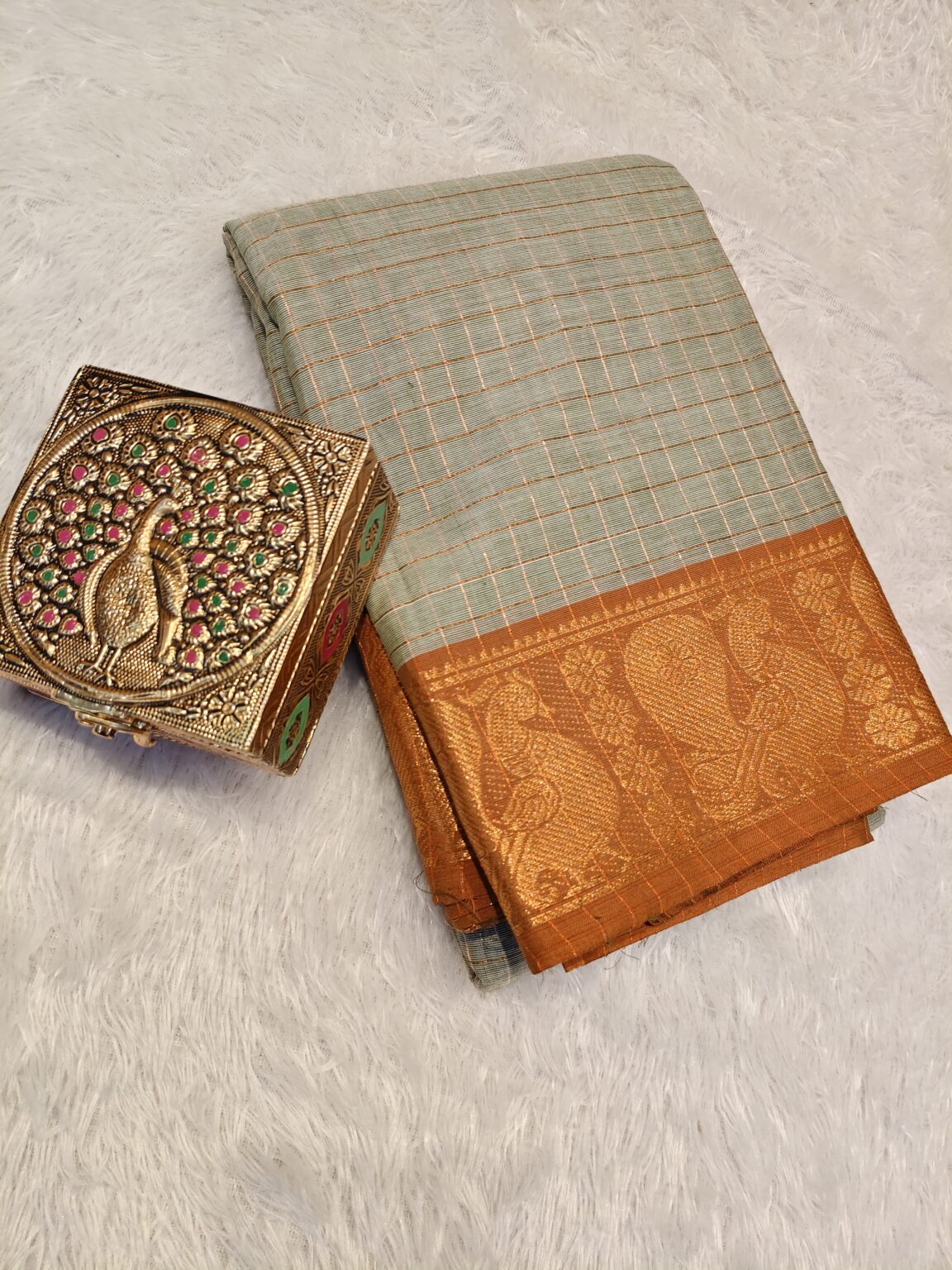 Ash golden zari checked body with rich golden zari contrast border, striped pallu.
