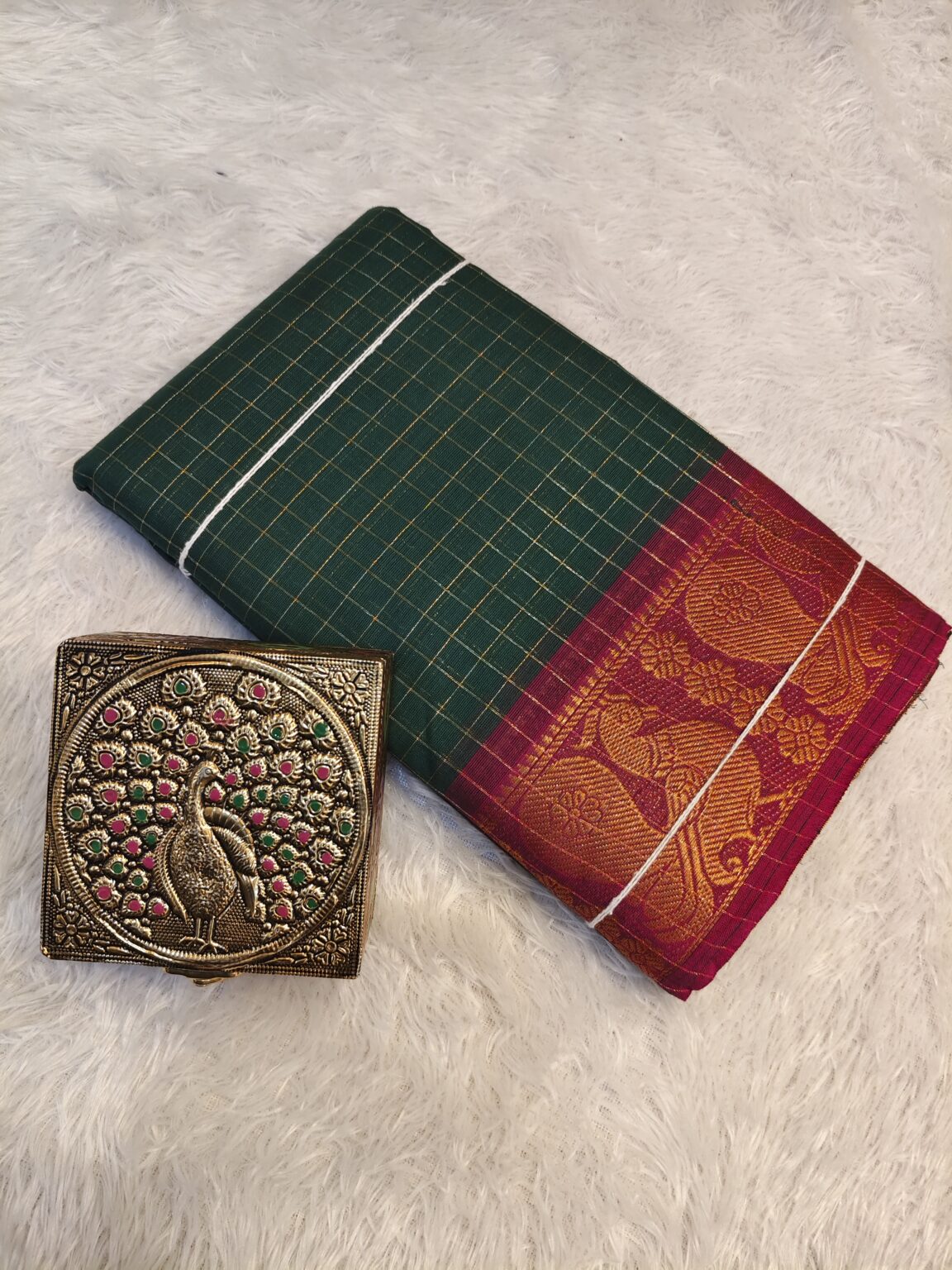 Bottle green golden zari checked body and rich golden zari contrast border, striped pallu.